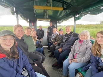 The PR&comms team and and staff from Carlton Marshes grinning on a trailer. 