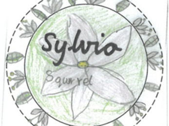 A coloured pencil drawing of a name badge with leaves and flowers. It says, 'Sylvia Squirrel'. 