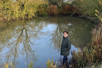 Louise Bond by one of the restored ponds on the farm 