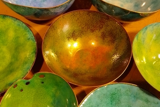An aerial view of different iridescent-coloured round bowls