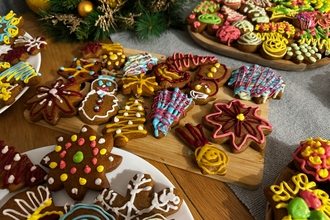 a selection of iced biscuits cut into Christmas shapes on wooden boards on a table