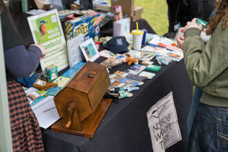 A variety of wildlife themed prizes displayed next to a tombola drum