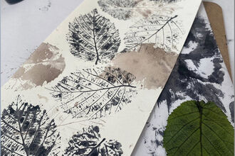 several leaf prints on a long white piece of paper