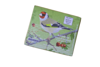 A soap bar with an illustrated goldfinch and Norfolk Wildlife Trust logo on the wrapper. 