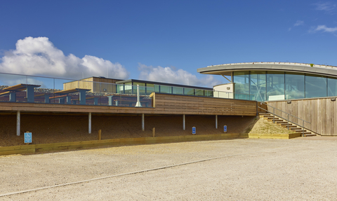 View of NWT Cley Marshes visitor centre and car park on a sunny day
