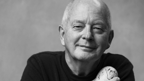 A black and white photo of Tim Birkhead facing the camera