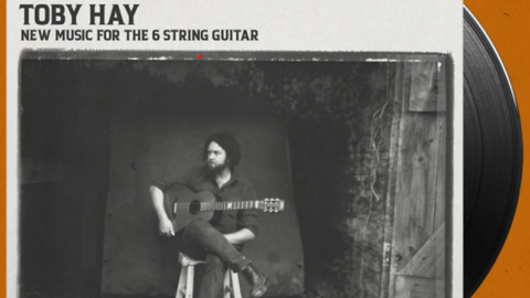 Vinyl record cover showing Tob Hay with his guitar sitting on a stool