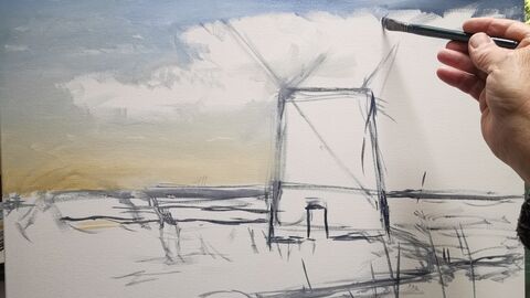 A hand holding a paintbrush working on a canvas of a building amongst reedbeds