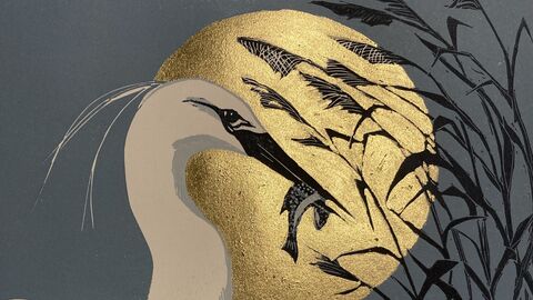 Picture of a white egret against a large moon and the sea