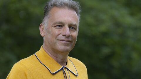 Chris Packham wearing a yellow top and facing the camera