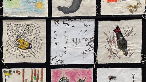 Squares containing embroidered scenes and objects relating to impacts of climate change.