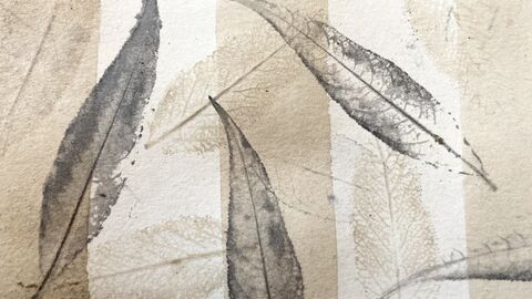 Grey leaf prints on a white and beige background