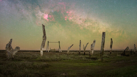 A photo of a view across Thornham at night time using special effect photography to colour the sky green and pink 