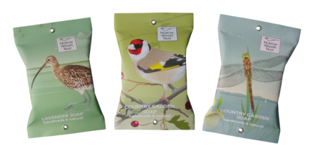 Three packaged soaps showing curlew, goldfinch and Norfolk hawker dragonfly illustrations
