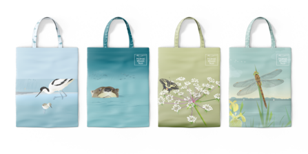 Four tote bags decorated with illustrations of avocets, otters, Norfolk hawkers and swallowtail butterflies