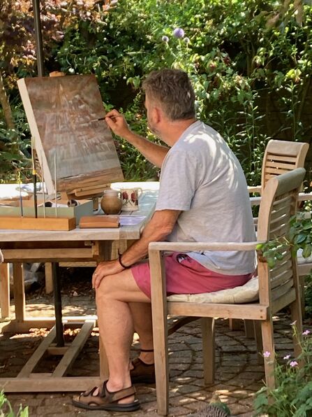 Artist Richard Whymark paints a canvas outdoors