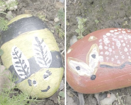 Two painted stones, decorated by children. The stone on the left is painted like a bee, while the stone on the right is painted like a fox
