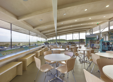Tables and chairs looking out over Cley marshes inside the Cley visitor centre