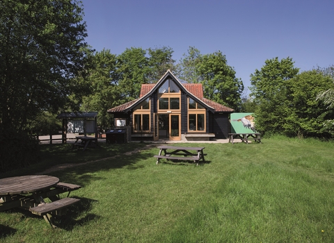 Hickling visitor centre at the back of a patch of grass on a sunny day