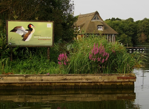 A view of the floating visitor centre and Ranworth signage from the water.