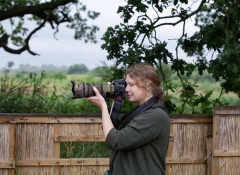 A woman using a dslr camera.