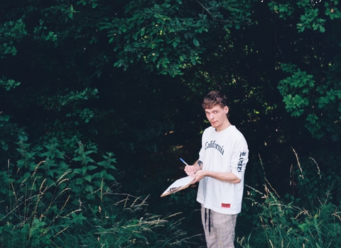 a young person writing at Sweet Briar Marshes