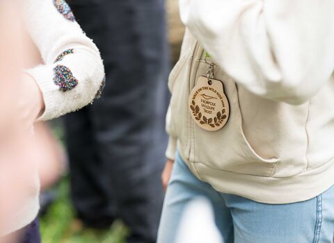 a young person with a walk on the wild side medal