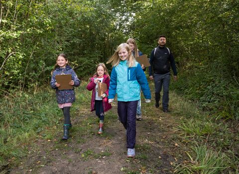 A group of young people walking through the woods